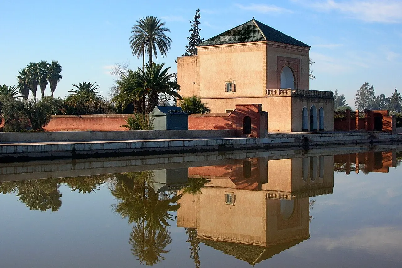 Menara's pavilion reflected in its large basin with gardens beyond
