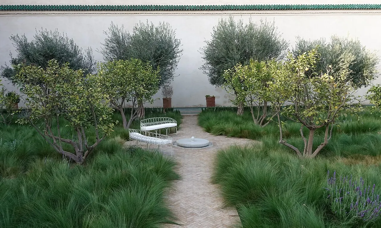 Paths and planted beds inside a courtyard at Le Jardin Secret
