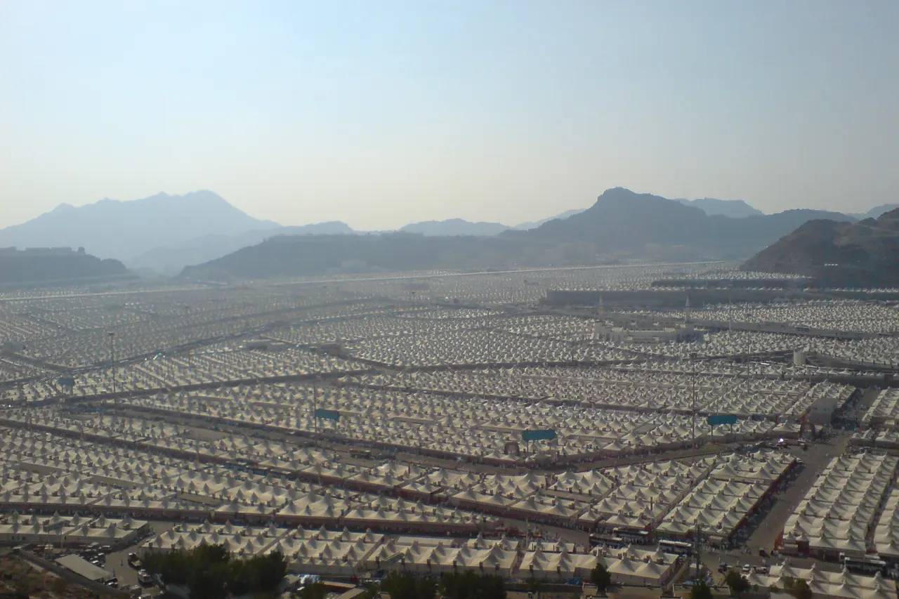 Rows of white pilgrim tents filling the valley of Mina