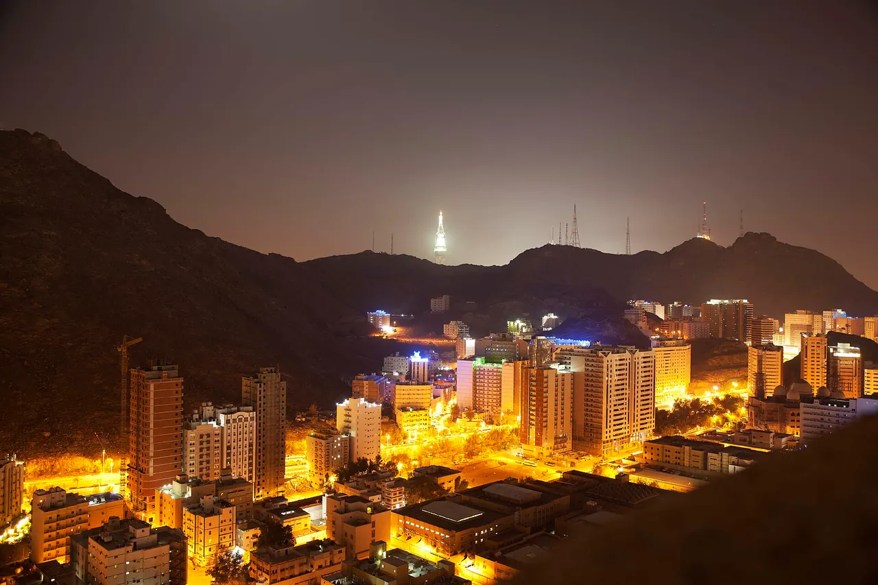 The Al-Aziziyah buildings and mountain setting at night, photographed in 2015