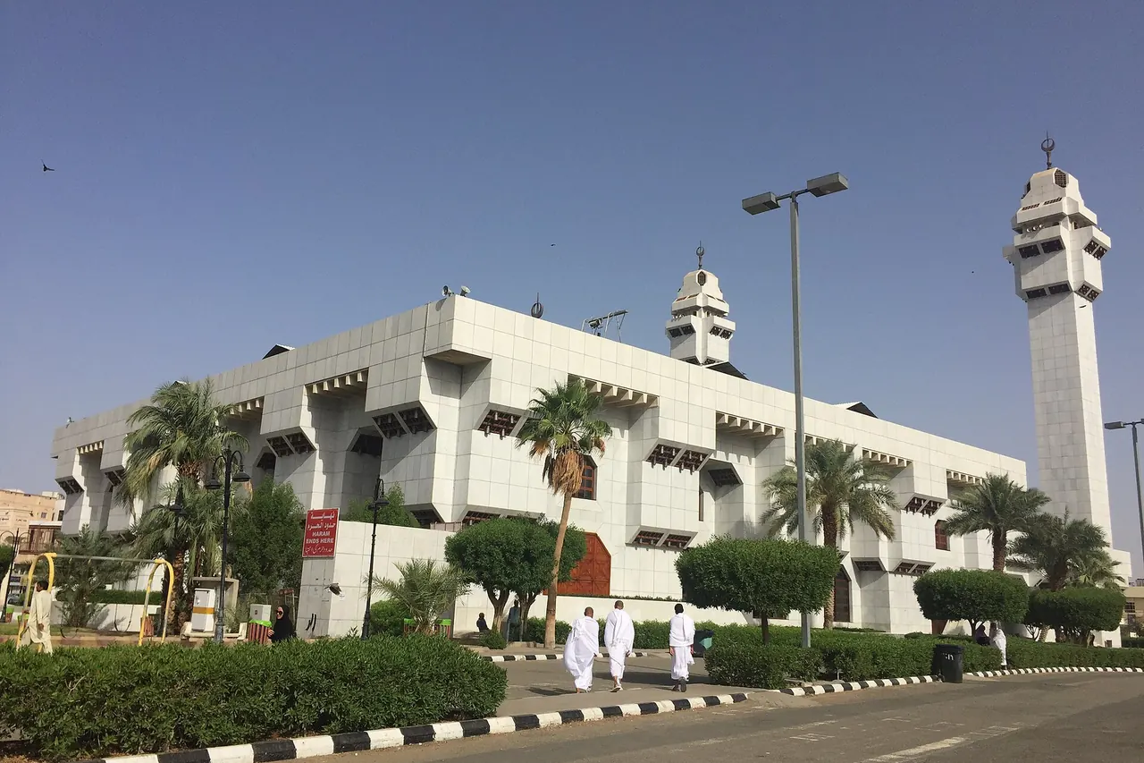 The white facade and minarets of Al-Taneem Mosque, also known as Aisha Mosque
