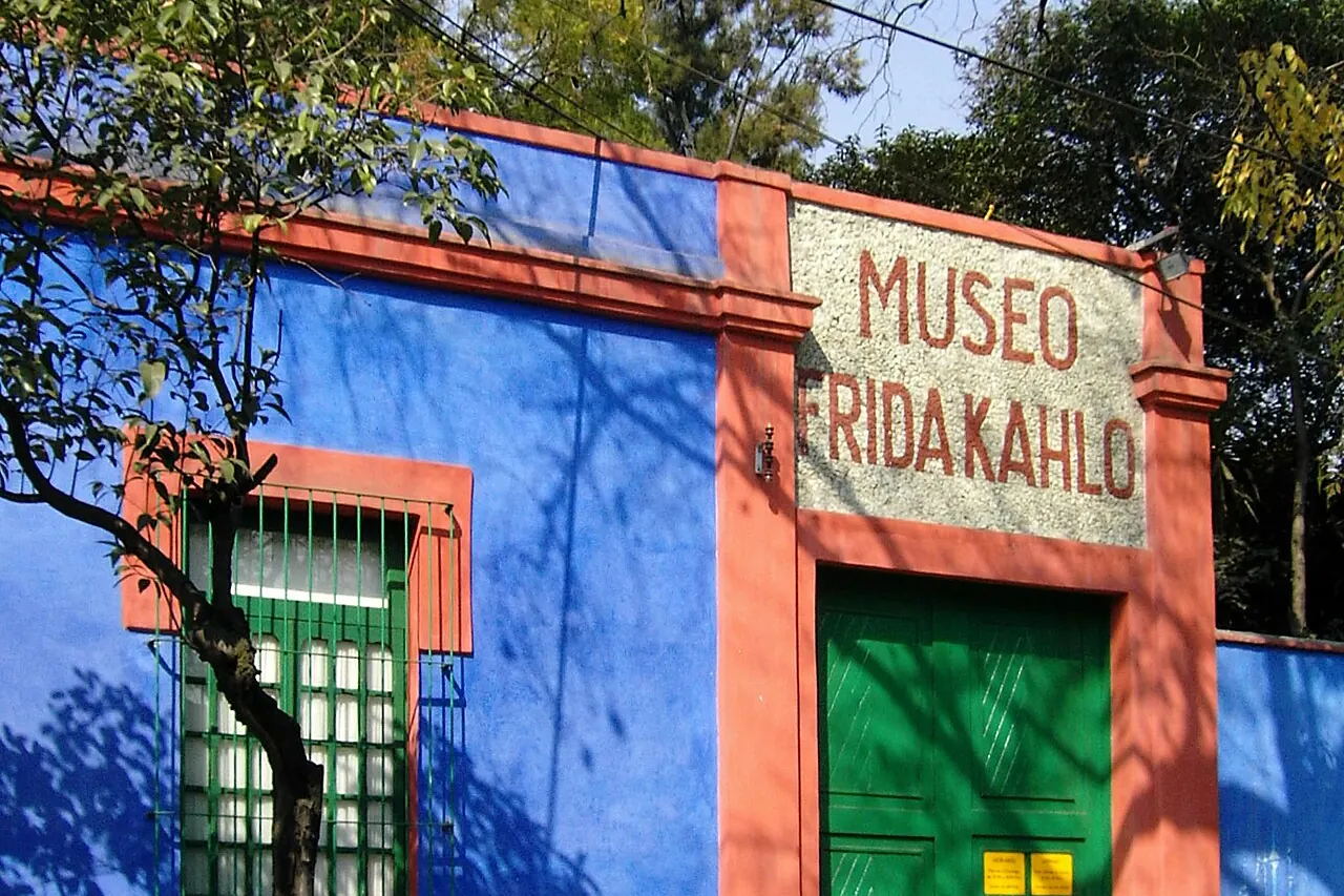 Blue walls, green doorway and museum lettering at Casa Azul