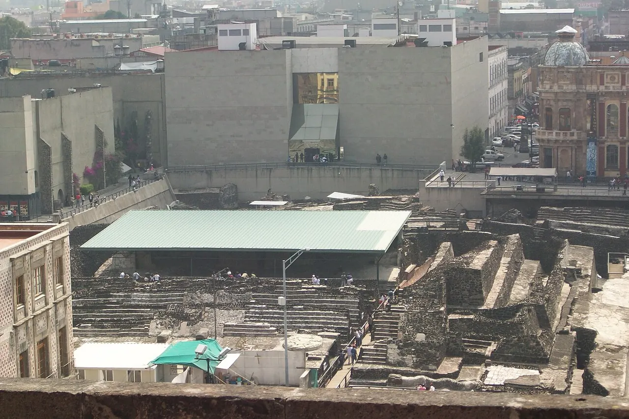 Excavated stone structures of Templo Mayor amid historic-centre buildings