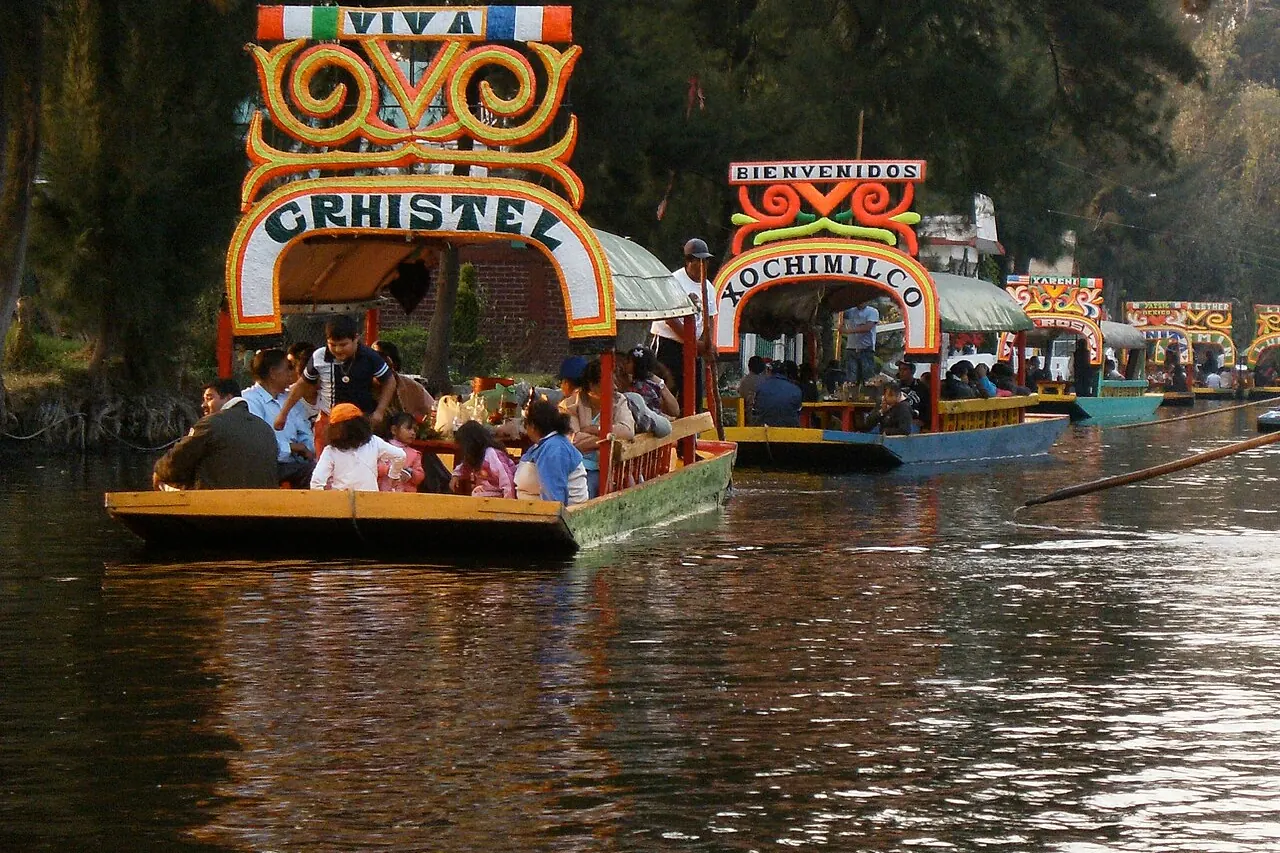 Colourful trajineras carrying visitors along a Xochimilco canal