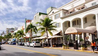 Art Deco buildings, palms and street life on Ocean Drive in Miami Beach