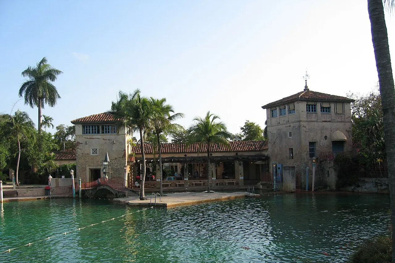 The historic Venetian Pool with stone features and palms in Coral Gables