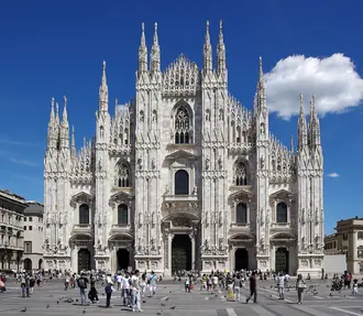 The marble facade and spires of Milan Cathedral above Piazza del Duomo
