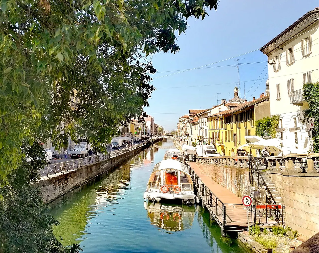 Canal-side buildings reflected in the Naviglio Grande in Milan