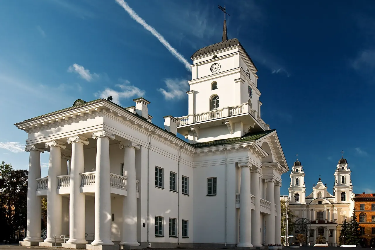 White classical Minsk City Hall with its clock tower and columned entrance
