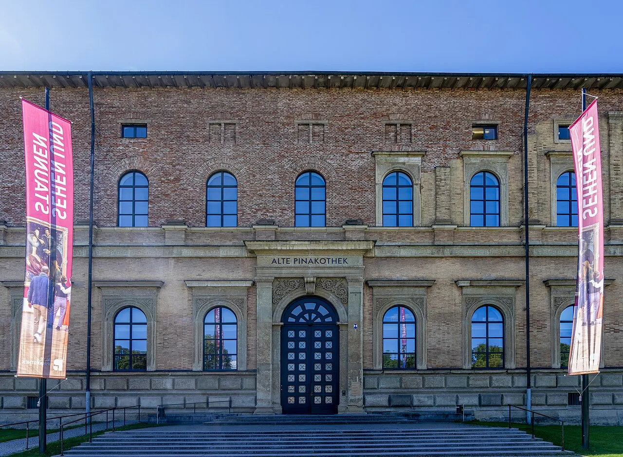 The brick facade and main doorway of Munich's Alte Pinakothek in daylight