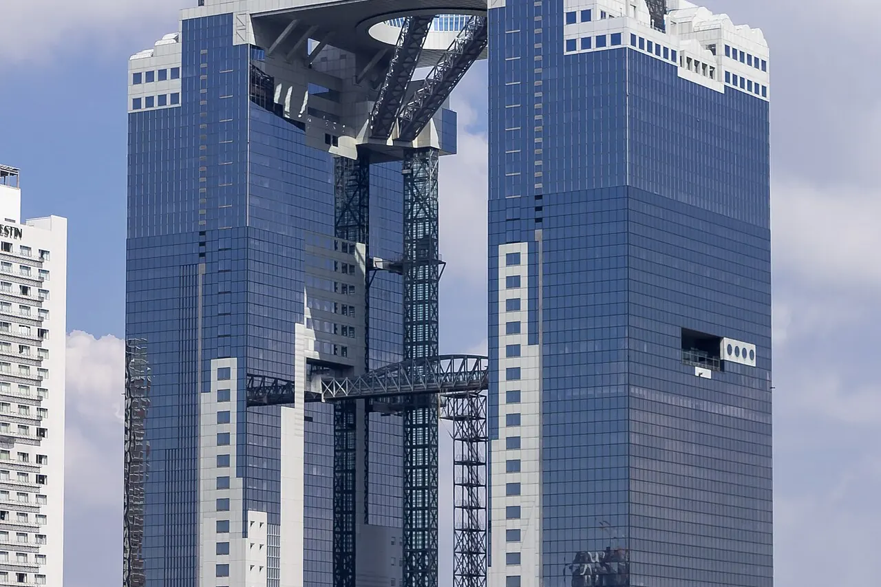 The linked towers of Umeda Sky Building viewed from street level