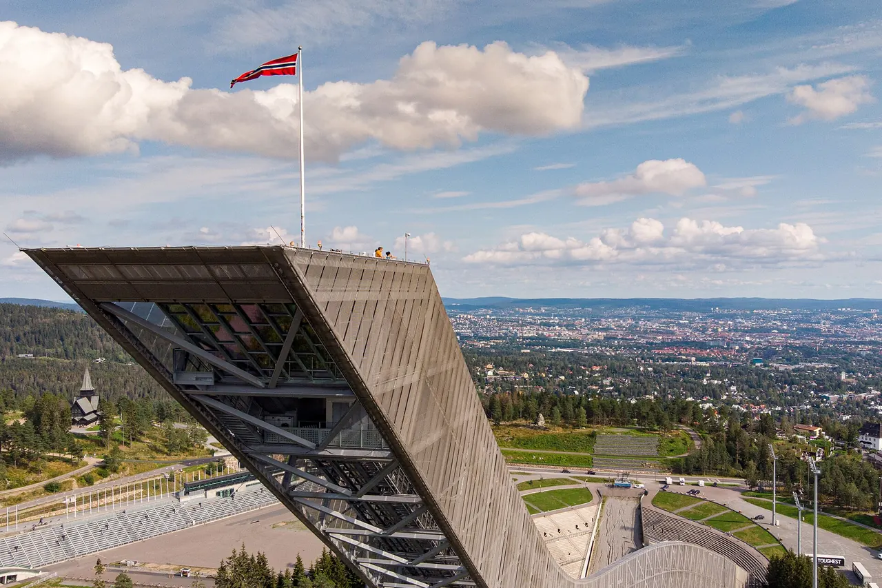 Holmenkollen's ski-jump structure above the wooded Oslo hills