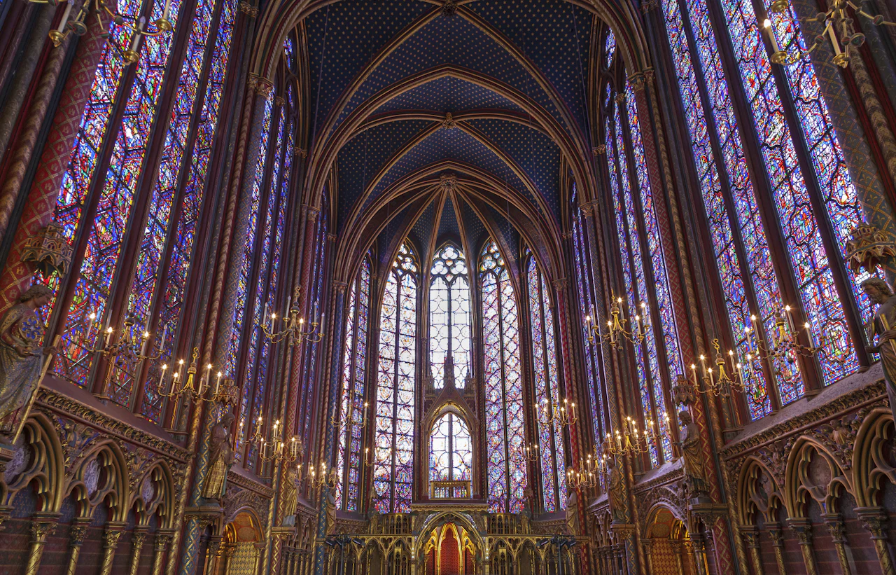Tall stained-glass windows beneath the vaulted ceiling of Sainte-Chapelle