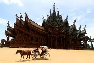 Carved wooden exterior and layered spires of the Sanctuary of Truth in Pattaya