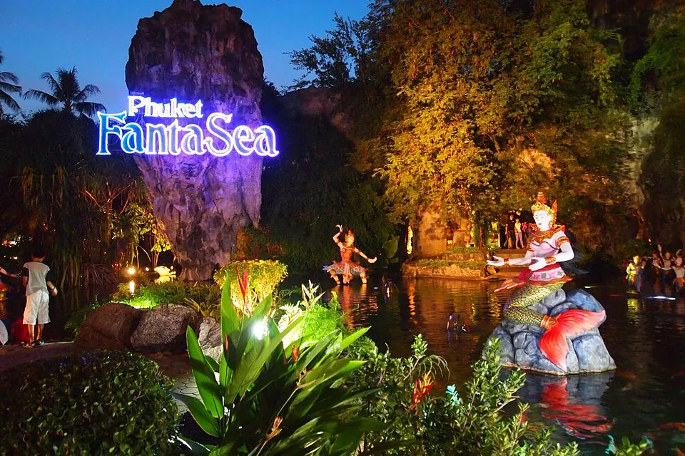 The illuminated Phuket FantaSea sign and themed entrance gardens at night