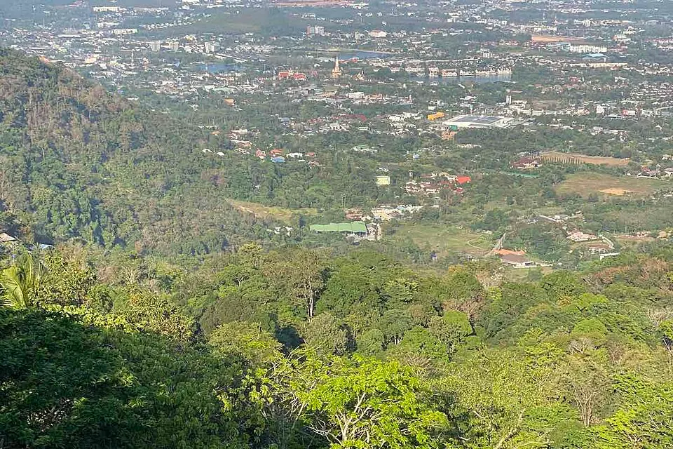 Phuket Town spread across the landscape below the wooded Khao Rang viewpoint
