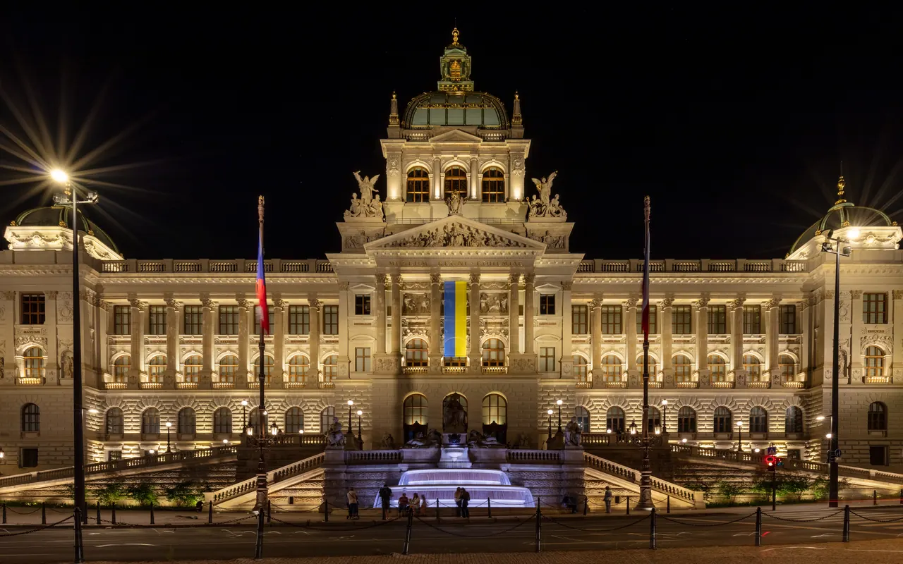 The illuminated historic National Museum building at the top of Wenceslas Square
