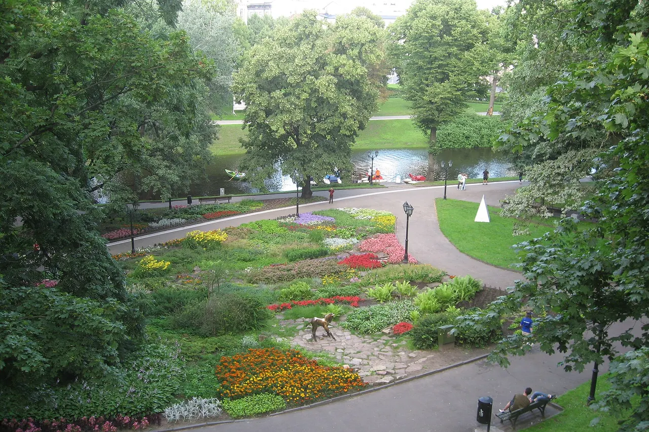Flower beds, trees and winding paths in Bastejkalns Park in Riga