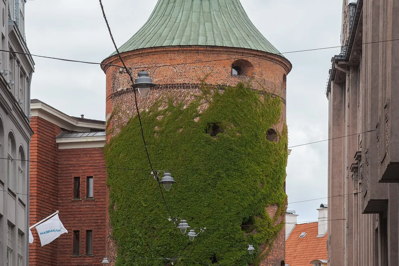 Round red-brick Powder Tower beside Riga's Old Town streets