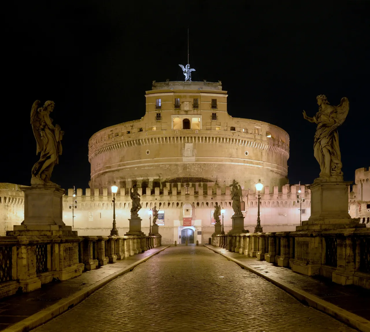 Castel Sant'Angelo illuminated beside the Tiber at night