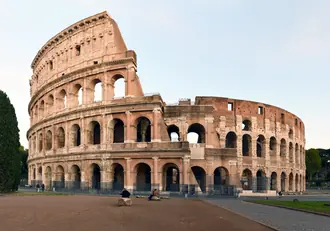 The Colosseum's arcaded exterior beside the surrounding archaeological area