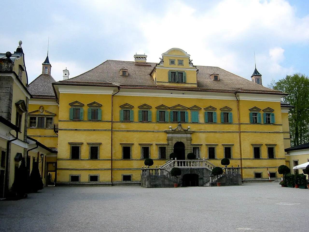 Yellow Hellbrunn Palace facing its forecourt near Salzburg