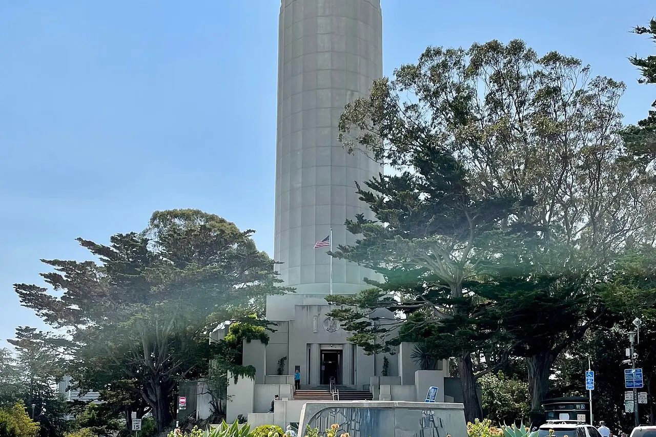 Coit Tower rising above trees on Telegraph Hill