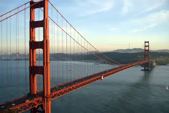 The Golden Gate Bridge spanning the bay in warm evening light