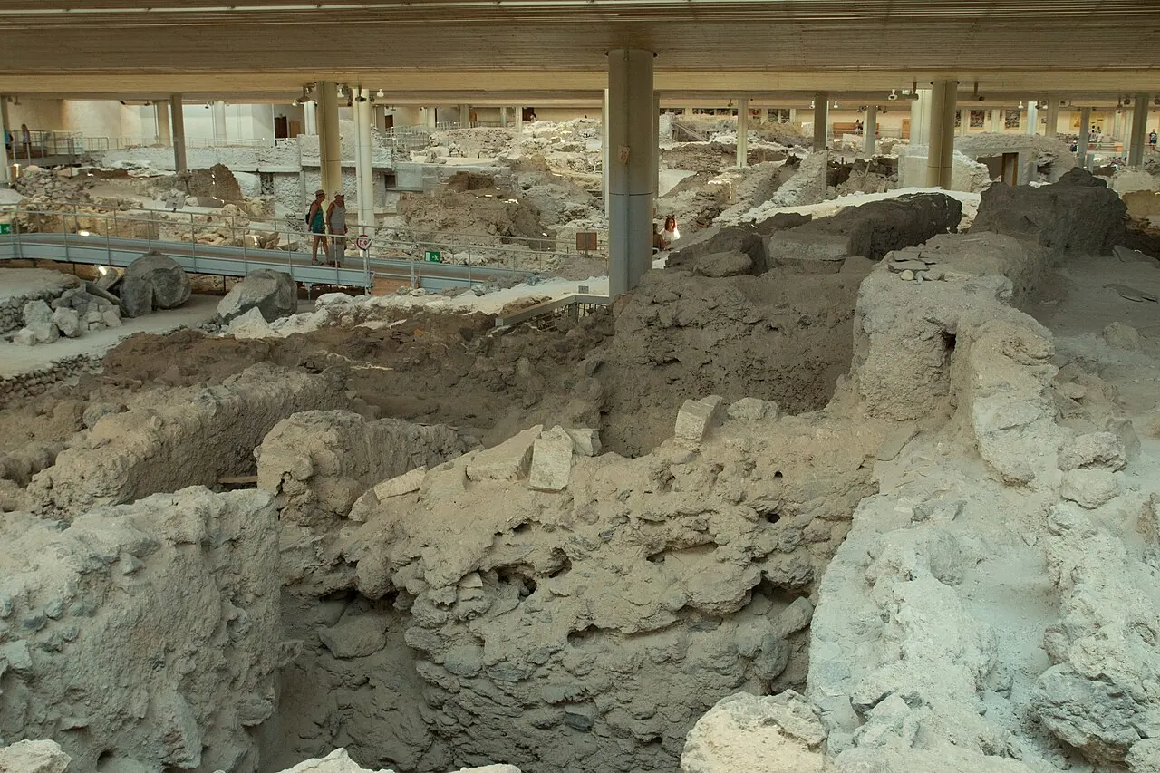 Excavated walls and streets beneath the protective roof at the Akrotiri archaeological site