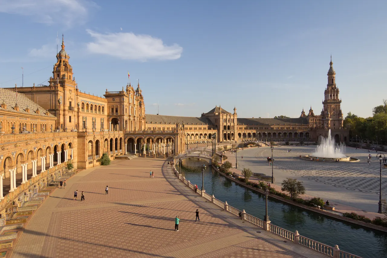 Curving arcades, tiled bridges and canal at Plaza de Espana in Seville