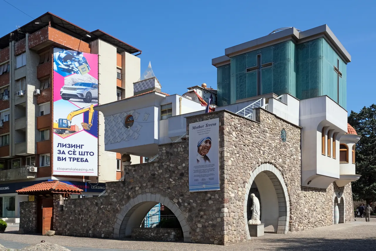 Distinctive stone and glass exterior of the Mother Teresa Memorial House