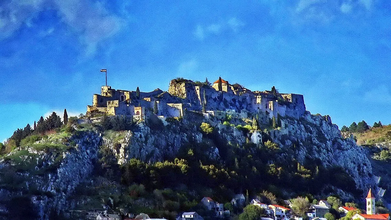 Klis Fortress extending along its rocky ridge above the surrounding countryside