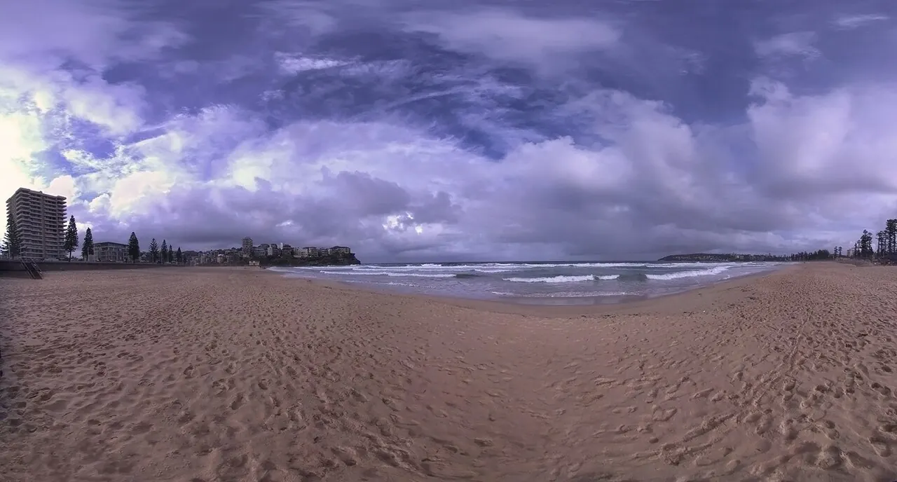 Manly's ocean beach and shoreline beneath an evening sky