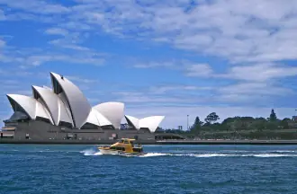 Sydney Opera House's white sails viewed from across the harbour