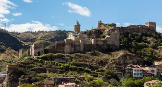 Fortified walls and the church within Narikala above central Tbilisi