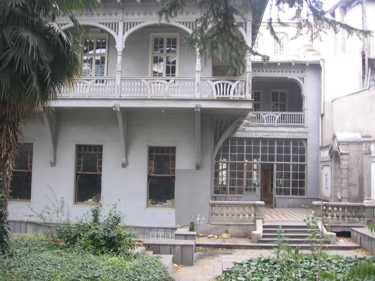 Garden-side facade and balcony of the Writers' House in Tbilisi's Sololaki district