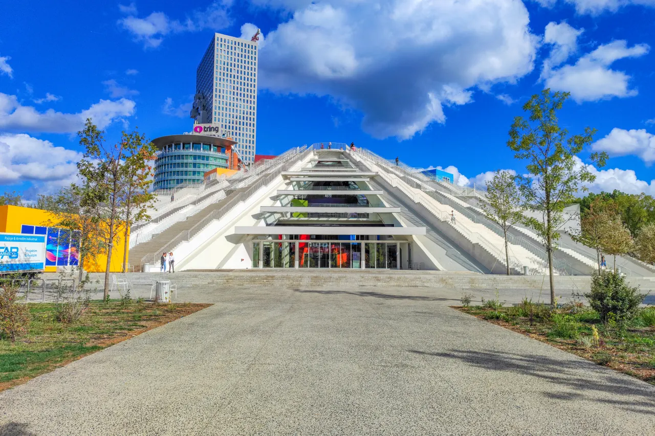The renovated Pyramid of Tirana with white sloping terraces and colourful adjoining structures