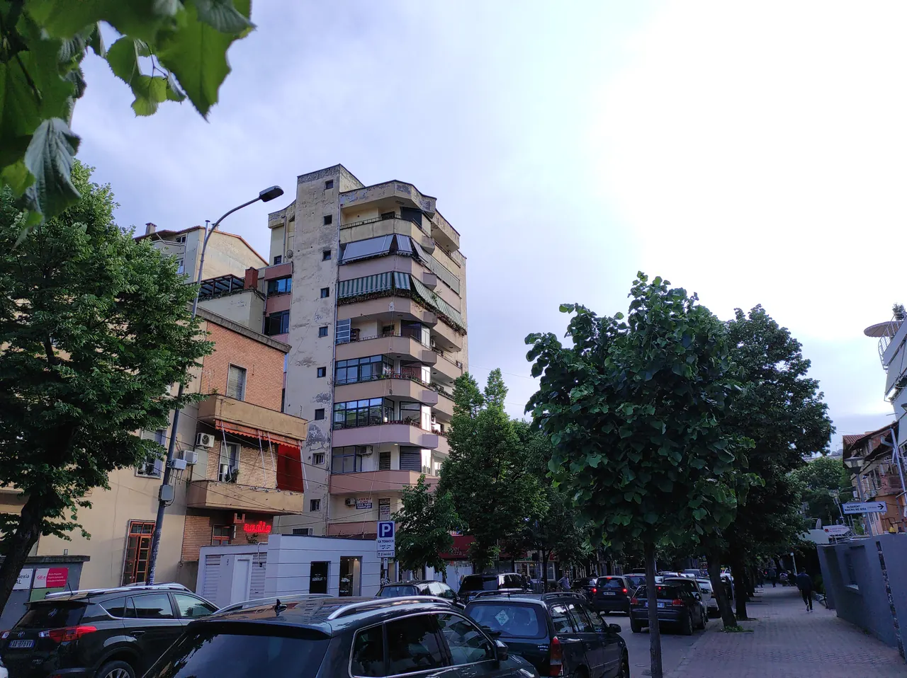 Street buildings, trees and traffic in Tirana's Blloku neighbourhood