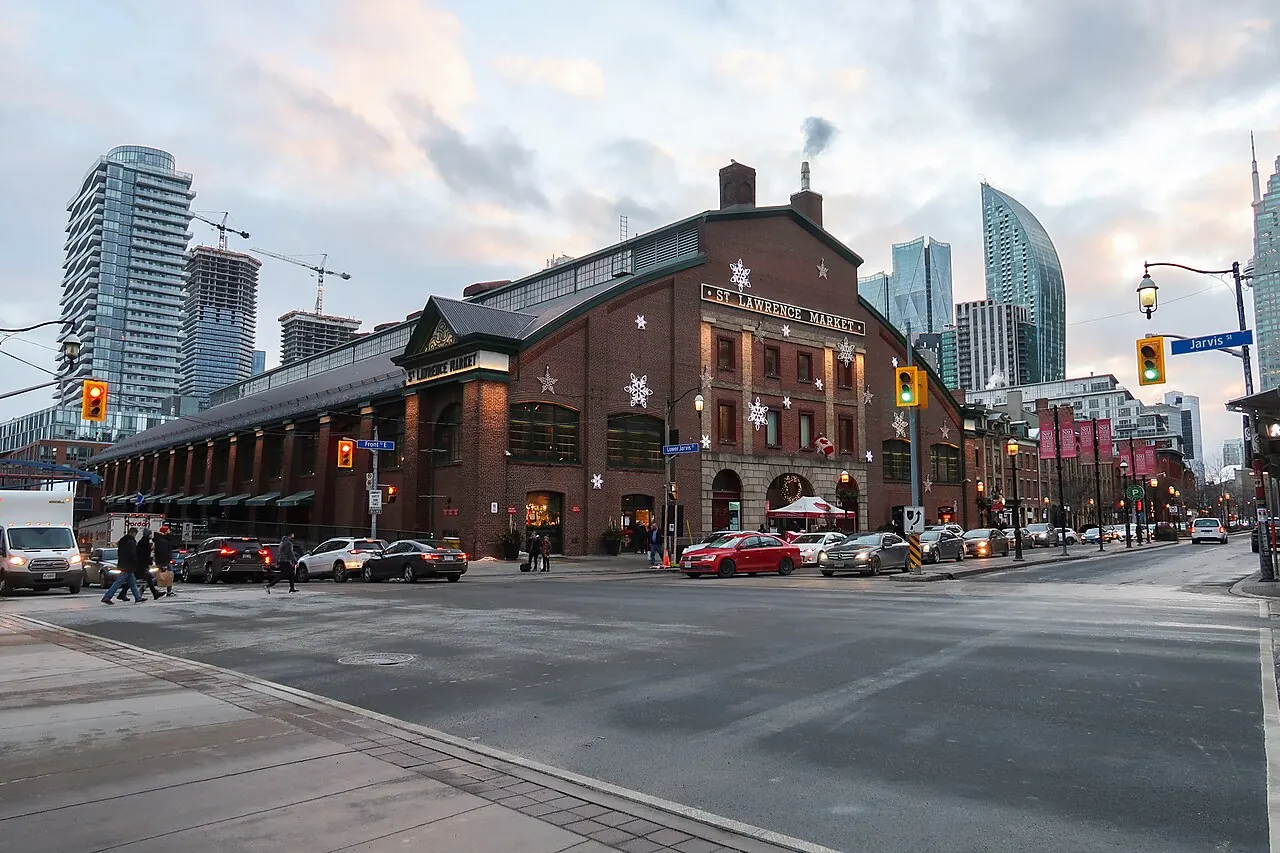 The red-brick South Market building at St. Lawrence Market beside a Toronto intersection