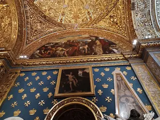 Decorated chapel vault and carved gilded stonework inside St John’s Co-Cathedral in Valletta
