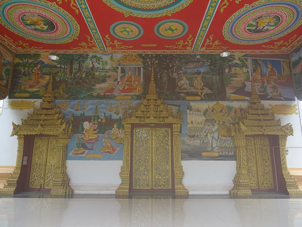 Painted ceiling panels and decorated doorways inside Wat Inpeng