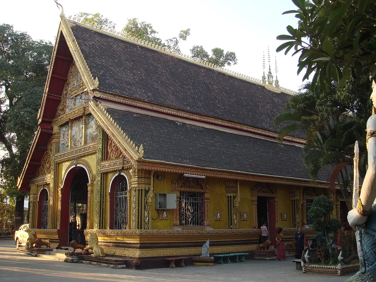 Wat Si Muang's decorated temple hall beneath its tiled roof
